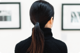 Woman looking at paintings