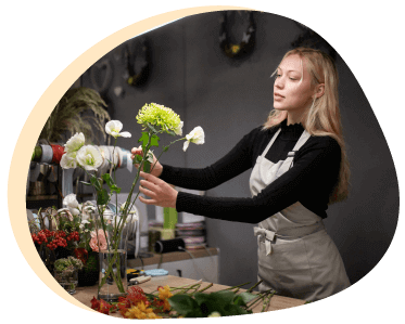 Woman Arranging Flowers In A Vase Photo